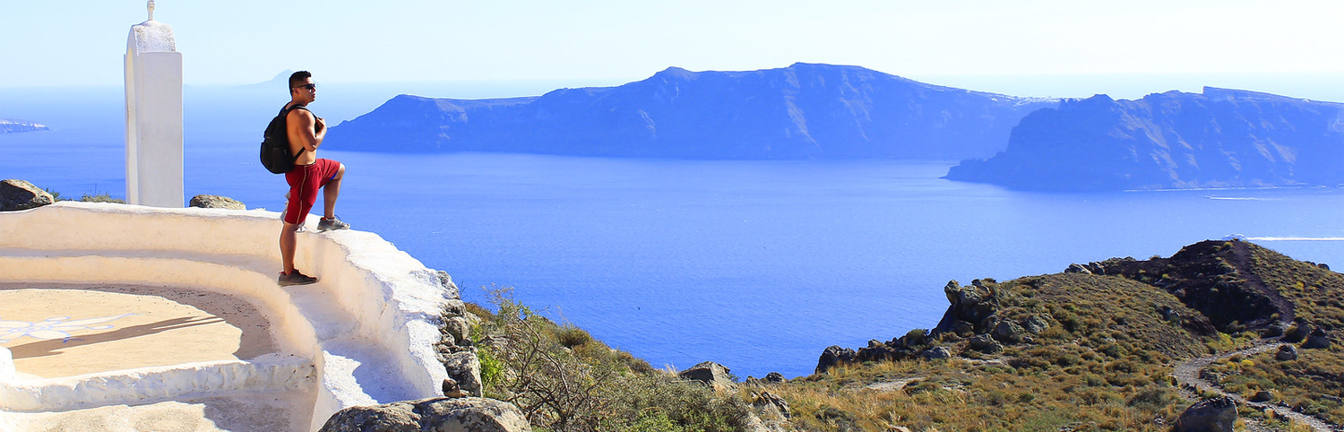 Hiker taking in the views in Santorini, a Greek Island in the South Aegean Sea